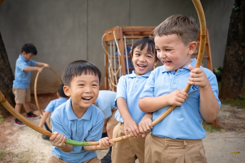 ISJ children playing outdoors with hoops