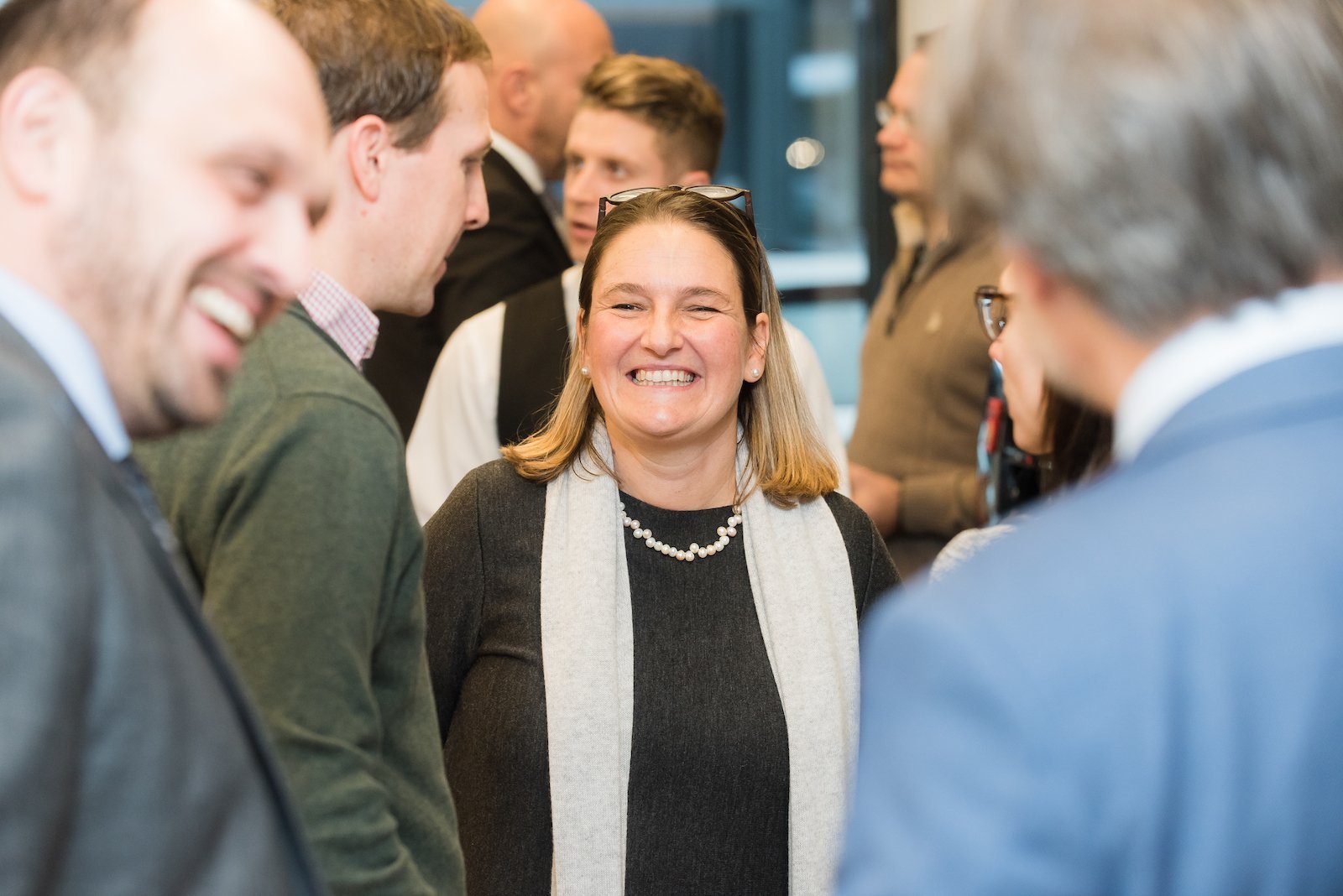 Parents talking and laughing together at a school gathering