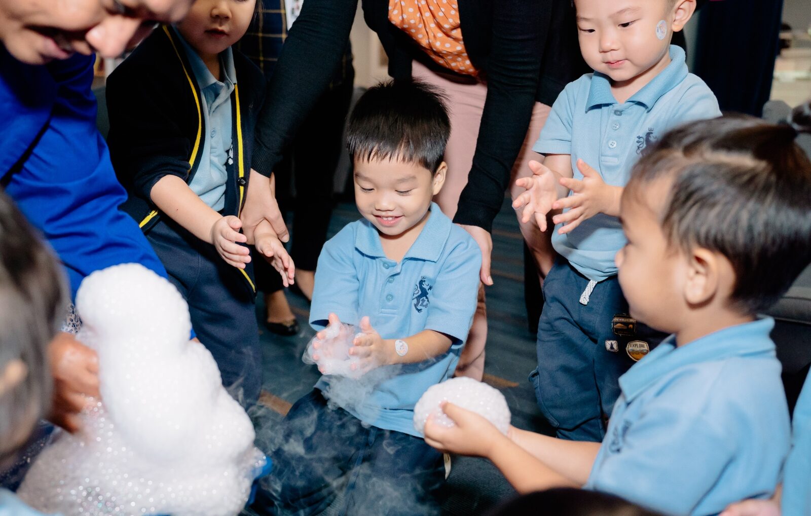 Young pupils exploring a dry ice experiment during a science session at ISJ Jakarta